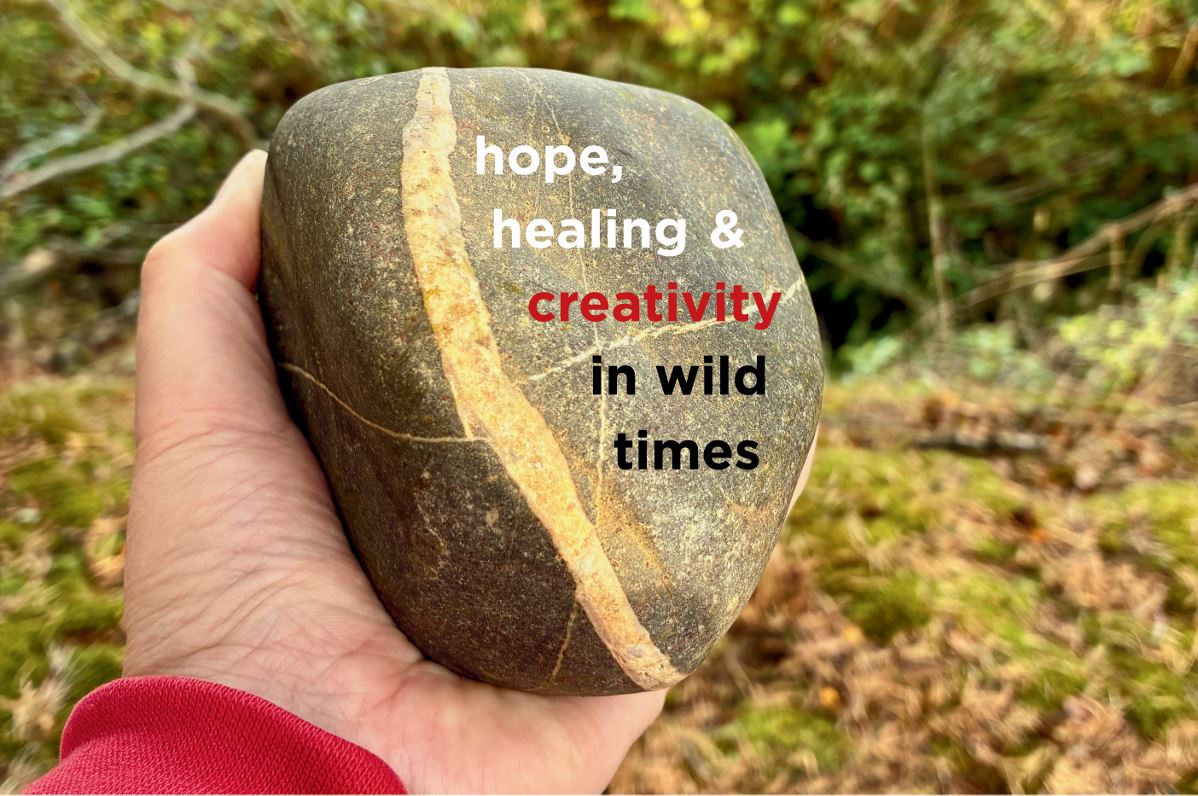 A hand holding a grey stone with a white quartz vein. Text over the stone reads 'hope, healing and creativity in wild times.'